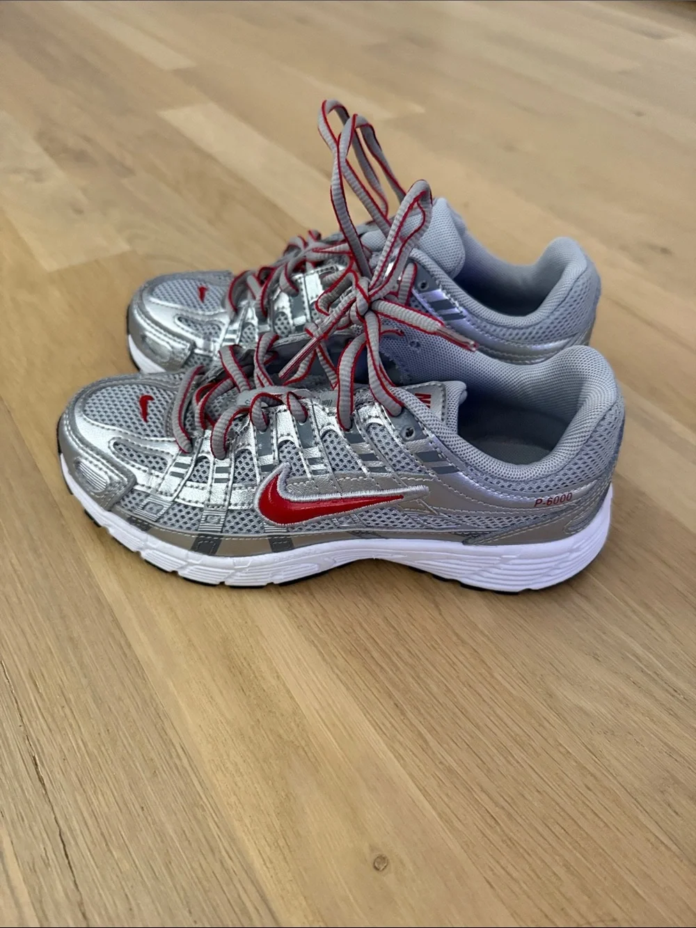 Nike Kids Silver Sneakers with Red Swoosh